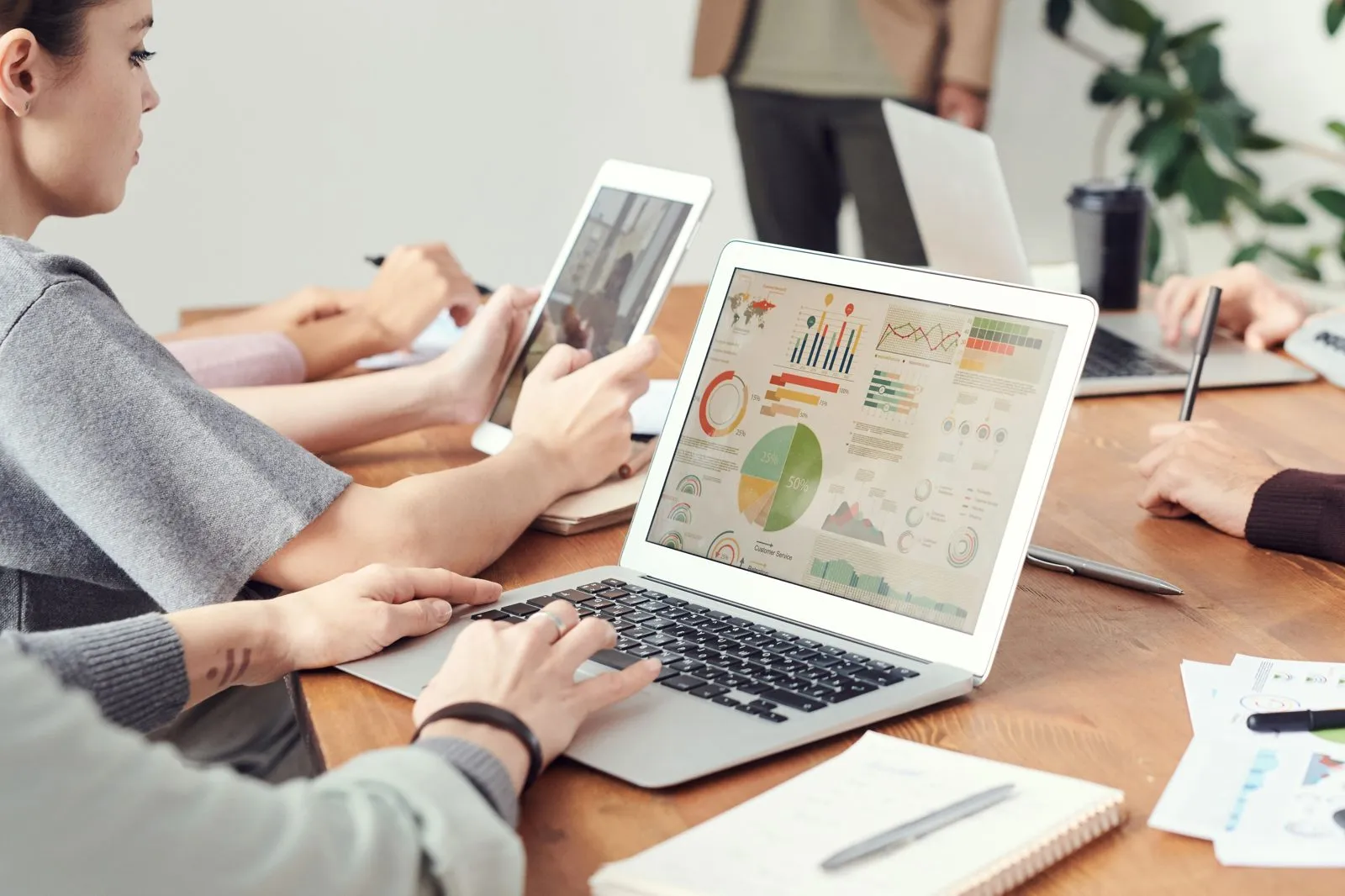 Marketing team reviewing campaign analytics on laptops